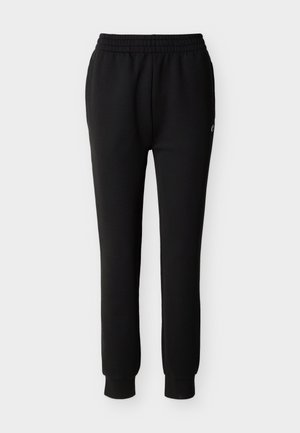 Pantalones deportivos negros con corte cónico, cintura y puños elásticos, con un pequeño logo blanco en el muslo superior.