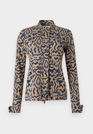 Patterned jacket in navy blue and beige, featuring geometric designs. Long sleeves with buttoned cuffs, mandarin collar, and front tie closure.