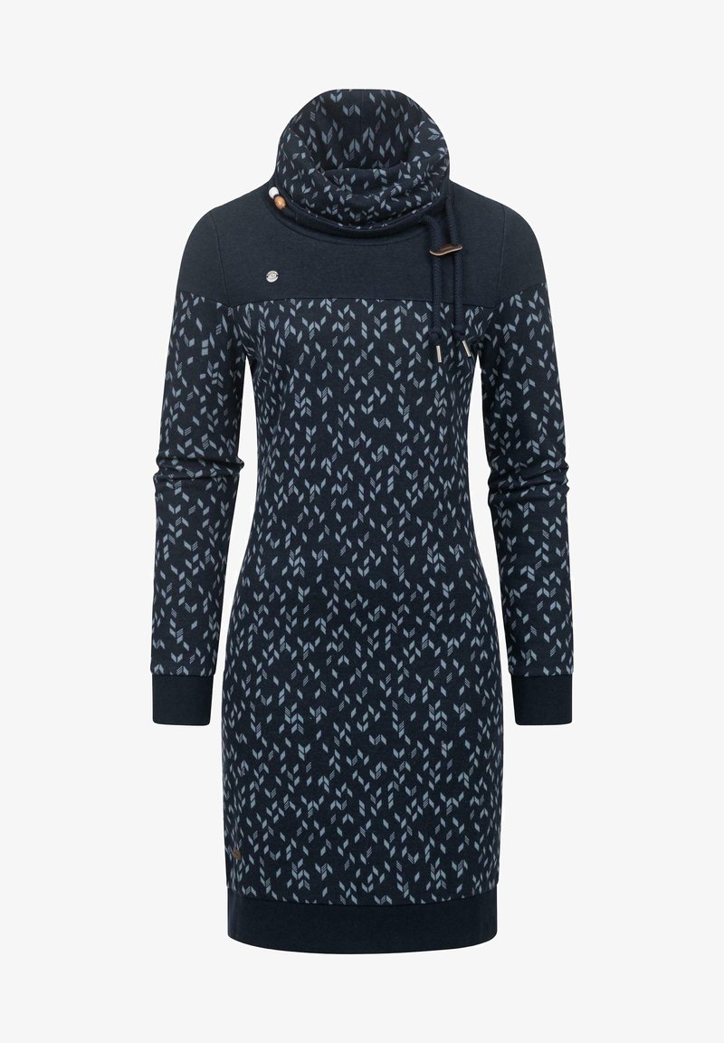 Tamsiai mėlyna suknelė su apykakle, kuri turi geometrinį raštą šviesiai mėlyna spalva. Ilgos rankovės ir tamsiai mėlyni rankogaliai bei apatinis kraštas.