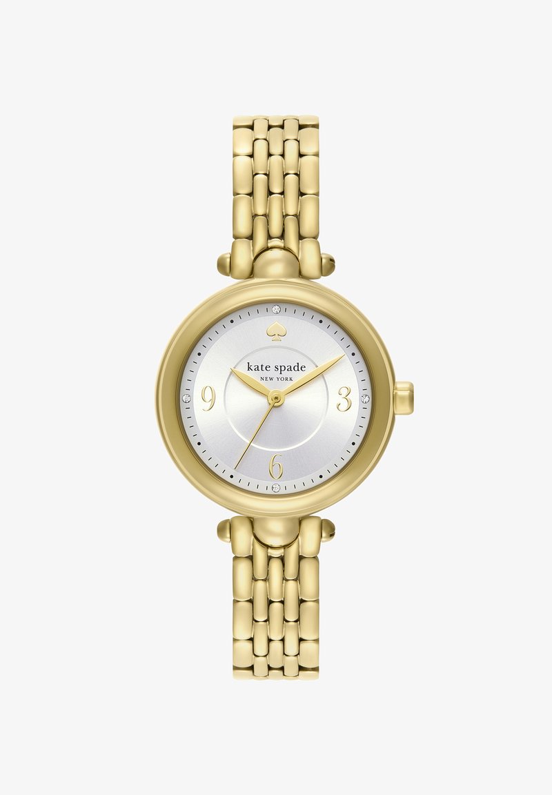 Kate Spade dames klokke i gullfarget tone med lenket armbånd, rund sølvfarget urskive, gullfargede visere og minimalistiske timeinndelinger ved 3, 6, 9 og 12.