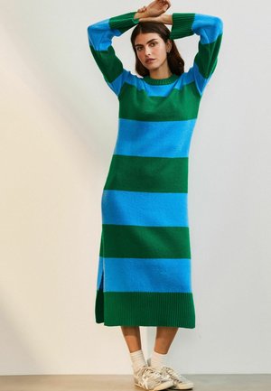 Knit dress featuring horizontal stripes in green and blue, long sleeves, ribbed hem, and side slits for ease of movement.