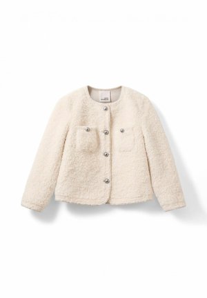 Kreminės spalvos trumpa striukė, pagaminta iš tekstūruoto audinio, su apvaliu kaklu, dviem priekinėmis kišenėmis ir sidabriniais užsegimais.