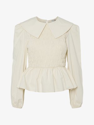 Cream-colored blouse with a large flat collar, smocked bodice, and puff sleeves. Features a peplum hem and back closure. Made from lightweight fabric.