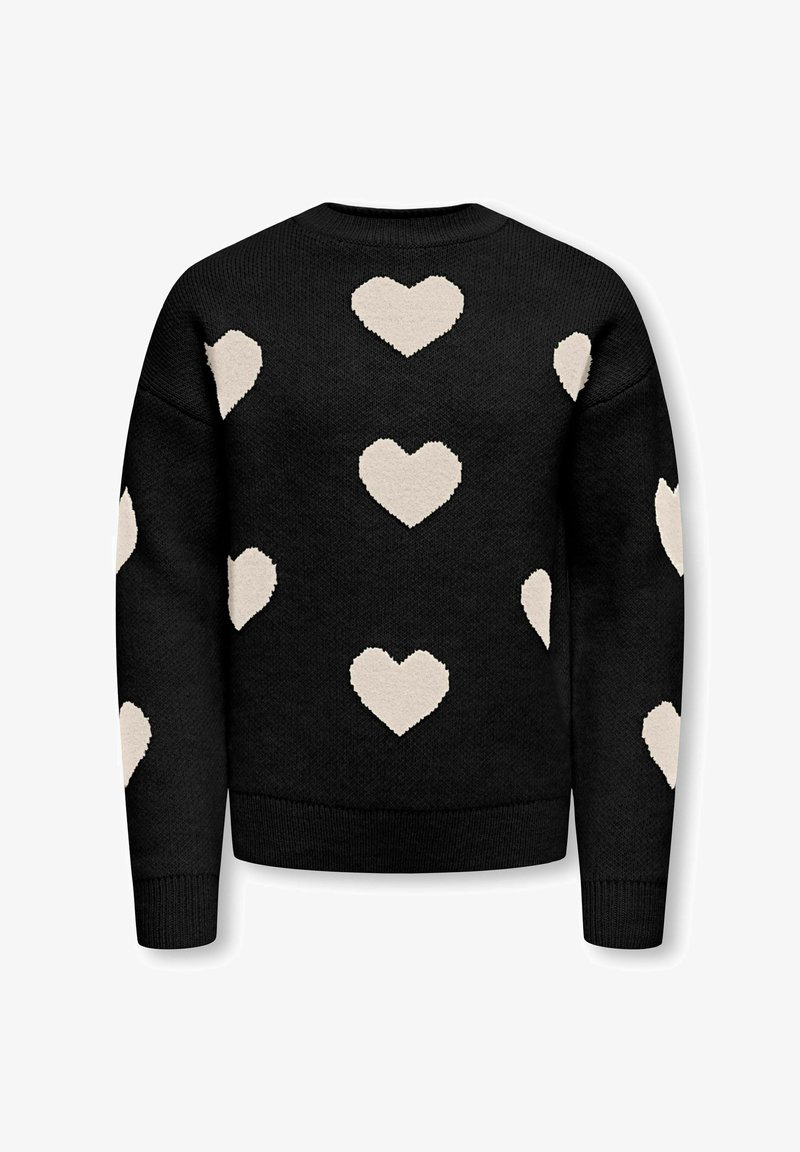 Pull noir en tricot avec plusieurs grands motifs de cœurs blancs répartis uniformément sur le dos et les manches.