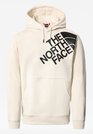 Crèmekleurige hoodie met kangaroo-zak en groot diagonaal zwart "THE NORTH FACE" logo op de borst, en capuchon met trekkoorden.