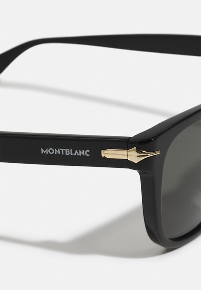 Čierne slnečné okuliare s matným povrchom, so zlatým kovovým akcentom a logom "MONTBLANC" na boku. Tmavé sklá zvyšujú UV ochranu.