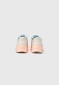 Sport shoes with a light gray mesh upper, pink rubber sole, and blue accents. Features a rounded design with a textured heel.