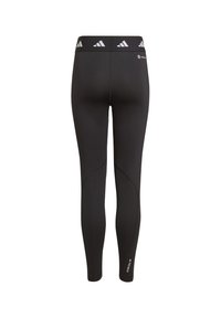 Leggings negros con una textura suave, cinturilla alta elástica que presenta tres rayas blancas y un detalle de logo cerca del tobillo.
