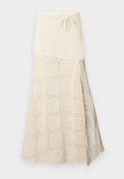 Horgolt szoknya, textúrált krém felső résszel és alul intricált négyzetmintával. Állítható zsinór a deréknál.