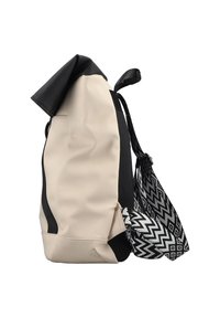 Beige waterproof backpack with a black top, featuring a patterned black and white sling. Side mesh detailing adds texture and functionality.