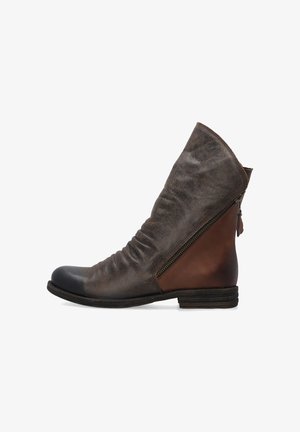 Brown leather ankle boot with a slouchy design, featuring a side zipper, round toe, and contrasting dark toe cap. Textured finish.