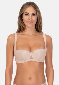 Jasnoróżowy stanik z teksturowanym wzorem, z fiszbinami, szerokimi ramionkami i małym detalem w postaci kokardki na środku. Gładki materiał o usztywnionym kształcie.