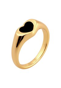 Gold ring with a smooth band featuring a heart-shaped cutout filled with black. Polished finish, elegant shape, and modern design.