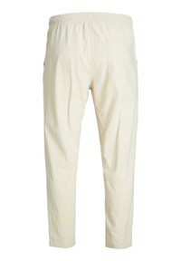 Beige, lightweight cotton trousers with an elastic waistband and side pocket, featuring a single rear pocket. Smooth texture and tapered fit.