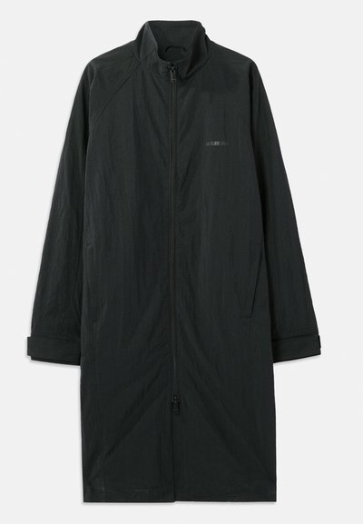 Black long coat with a high collar, featuring a full front zipper, and made of lightweight, textured fabric. Includes cuffed sleeves and subtle branding.
