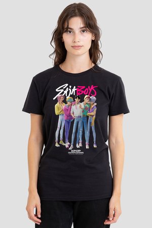 Woman wearing a black T-shirt with a colorful cartoon band of five young men and text "Saja Boys" and "Kpop Demon Hunters" on front.
