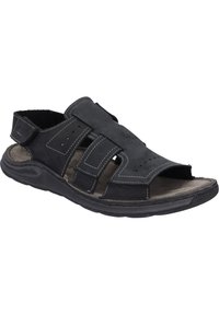 Sandal in pelle nera con punta aperta, cinturini regolabili e cuciture grigie. La soletta testurizzata e la suola in gomma offrono aderenza e comfort.