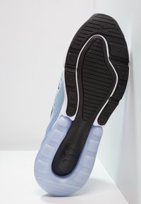 Light blue athletic shoe with a black rubber sole, textured patterns, white accents, and visible cushioning pods in a gradient blue finish.