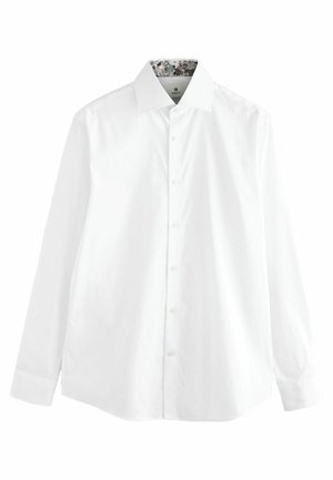 Camicia bianca a maniche lunghe in cotone liscio, con chiusura a bottoni e colletto interno a fantasia. Taglio classico con orlo curvo.