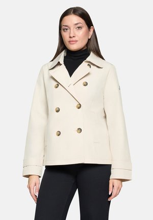 Beige double-breasted jacket made of smooth fabric, featuring large round buttons, a notched collar, and side pockets.