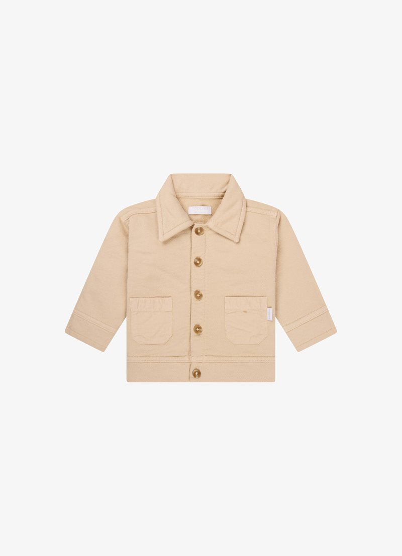 Veste beige avec un col, fermeture à boutons et deux poches avant. Fabriquée en coton, avec un design de tissu texturé.
