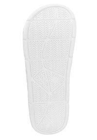 Witte rubberen schoenzool met textuurpatronen, groeven en gripontwerpen, met golvende lijnen en geometrische vormen voor betere grip.