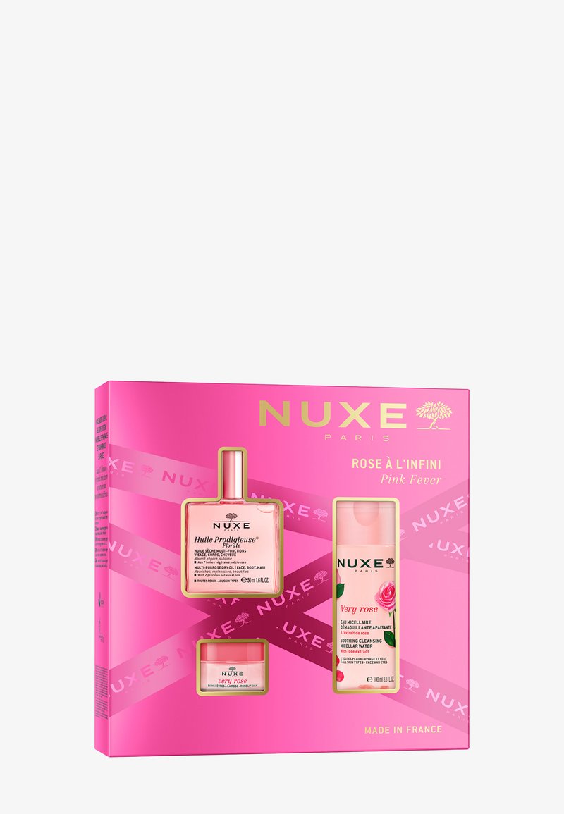 NUXE presentlåda i en rosa box innehåller tre produkter: en flaska med rosa olja, en flaska med rosa micellärt vatten och en krämkruka med blommönster.