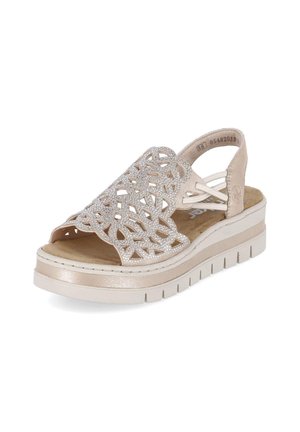Beige Keilsandale mit offenem Zehenbereich, dekorativem Cut-out-Muster, glitzernden Details, elastischen Seitenriemen und dicker profilierten Sohle.