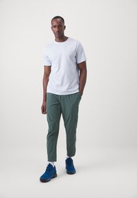 Nike Performance UNLIMITED PANT - Treningo apatinė dalis - vintage green/black