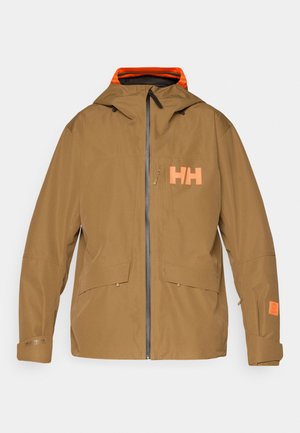 Brun vattentät jacka med framzipper, huva och två stora framfickor. Har ett orange logotyp och innerfoder med accentfärger.