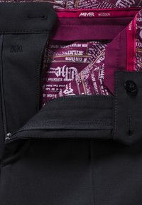 Schwarze Hose mit einer Reißverschlusstasche und einem maroonfarbenen, gemusterten Innenfutter. Der Stoff hat eine glatte Textur und ist mit feinen Nähten versehen.