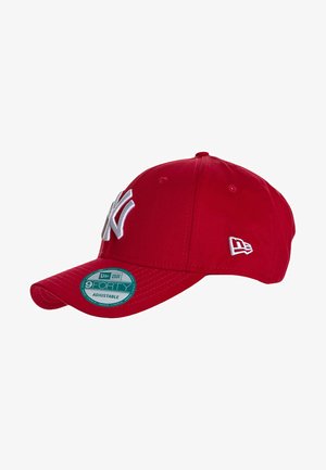 Red baseball cap with a curved brim, featuring a white logo on the front and an adjustable strap. Material is fabric with a smooth texture.