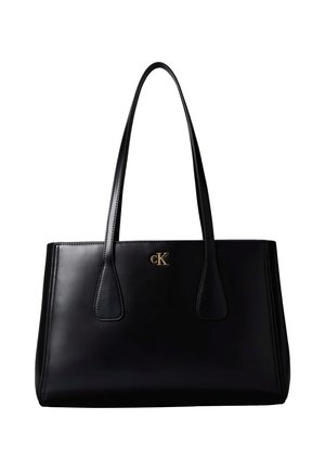 Sac à main en cuir noir avec deux longues lanières et petit logo CK doré au centre devant, forme rectangulaire avec coutures latérales légèrement vers l'extérieur.