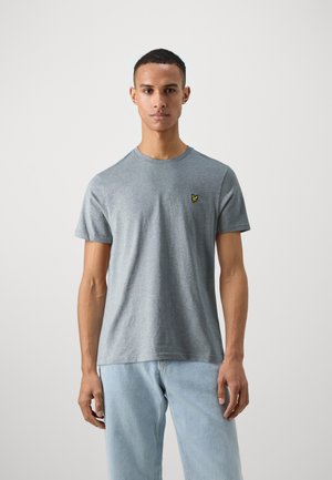 Grå kortärmad t-shirt i bomull med rund halsringning. Har en liten gul logotyp på vänstra bröstet.