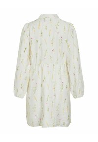 Valge pikkade varrukatega kleit peene kollase ja roosa lillemustriga, kogutud vöökohaga ja põlvikvarrukatega, nähtav tagantpoolt.