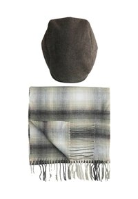 Dark gray flat cap above a folded gray plaid scarf with fringe on a white background.