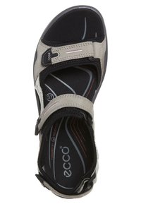 Open-toe sandal featuring grey synthetic material, adjustable Velcro straps, cushioned footbed, and contrasting black and red design elements.