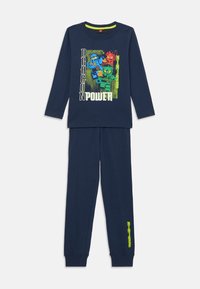 Navyblaue Pyjamas aus Baumwolle. Das langärmlige Oberteil zeigt ein buntes Drachen-Ninja-Motiv und den Text "DRAGON POWER". Hose mit elastischem Bund.