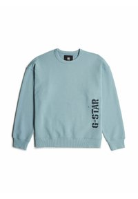 Sudadera de color azul claro, hecha de tejido suave, con un cuello redondo y puños de canalé. Impresión negra de "G-STAR" en el lado izquierdo.