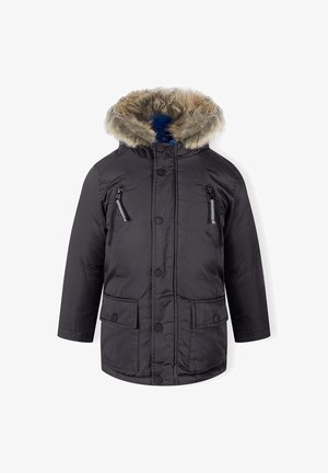 Czarna, pikowana kurtka z kapturem wykończonym futrem, z zamknięciem na zamek błyskawiczny na kieszeniach na piersi i z guzikiem. Posiada niebieską podszewkę i dwie kieszenie z przodu.