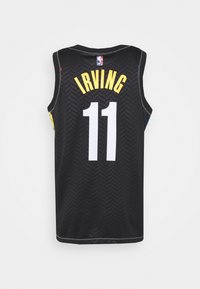 Black basketball jersey featuring a herringbone pattern, with "IRVING" and number "11" in white and yellow lettering on the back.