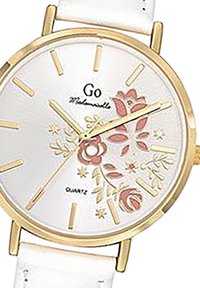 Montre en quartz ronde avec un cadran blanc, des accents dorés, un motif floral en rose et vert, et un bracelet en cuir blanc.