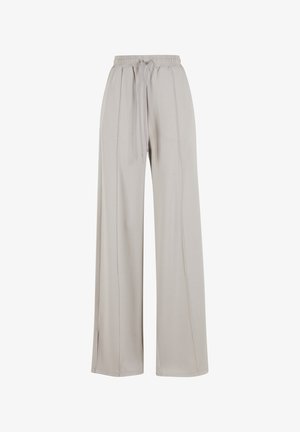 Pantalons larges beige clair en tissu doux, avec une taille à cordon de serrage et de subtiles fentes latérales pour un détail de design supplémentaire.