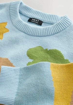 Light blue knitted sweater featuring colorful accents: green leaf, yellow, and brown shapes. Ribbed neckline and cuffs with a soft texture.
