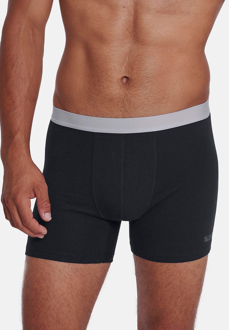 Boxer en coton noir avec une ceinture élastique grise, design ajusté et détails de couture discrets. Uni, sans motifs ni logos.