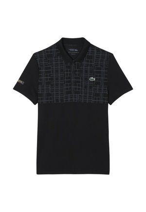 Black Lacoste polo shirt with a gray geometric grid pattern on the upper chest and the brand's green crocodile logo on the left side.