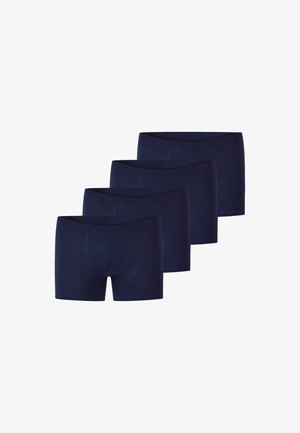 Quatre paires de boxers pour hommes bleu marine disposées en décalé sur un fond blanc.