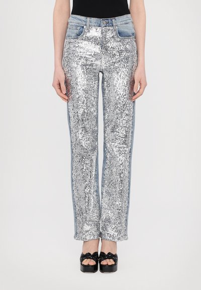 Silver sequin jeans with a straight leg design, featuring a light blue denim waistband and side panels. Smooth texture and reflective finish.