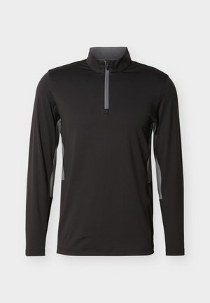 Fekete hosszú ujjú sportpulóver szürke félhosszú cipzáras gallérral és szürke oldalsó betétekkel, világos, egyszínű háttér előtt bemutatva.