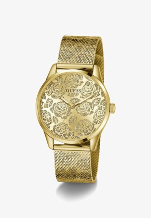 Montre-bracelet pour femme ton or avec cadran à motif floral, index en cristal, bracelet en maille et affichage analogique à trois aiguilles par Guess.